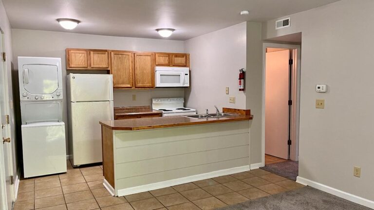 Pine Bridge Apartments galley kitchen including stacked washer/dryer